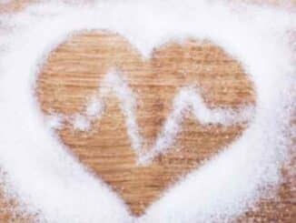 Salt in the shape of a heart on a wooden surface