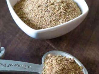 salt free taco seasoning in a small white bowl and heart-shaped measuring spoon