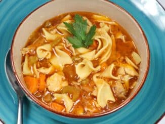 Low Sodium Chicken Noodle Soup in a bowl on a blue plate.