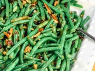 Green Beans with cranberries and almonds on a white platter