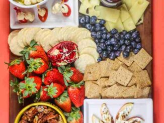 cheese, fruit, snacks on a board